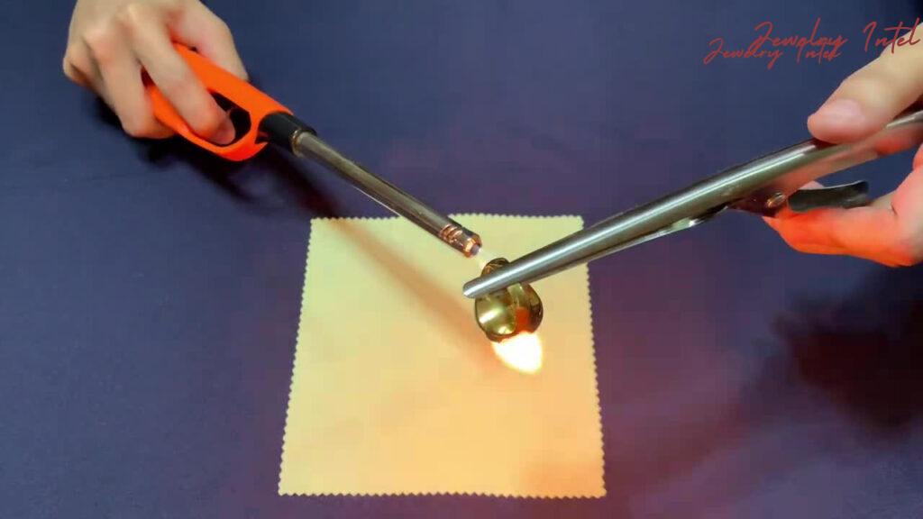 hold the gold in the flame