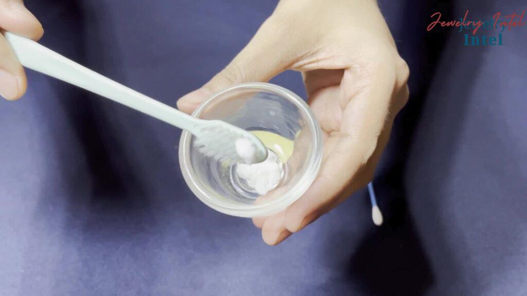 toothpaste on a brush to clean silver